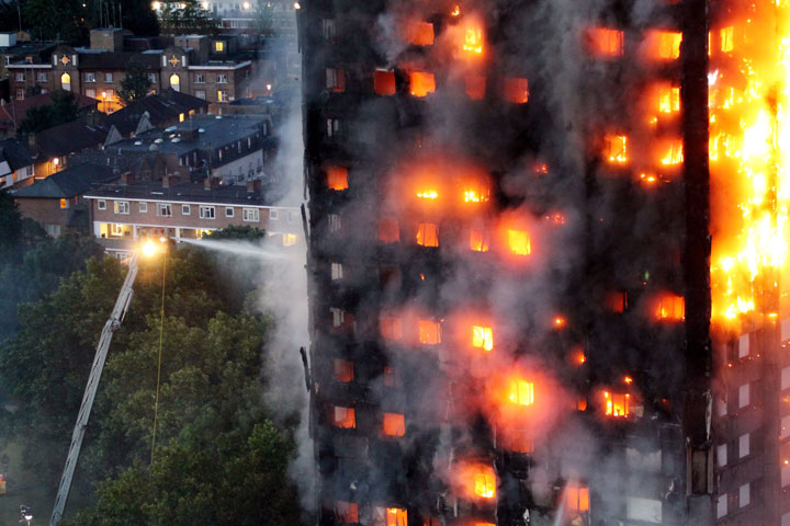 Firefighters spray a fire in London