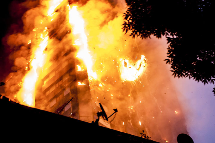 Falling burning debris at the scene of a huge fire