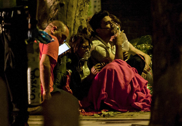 Members of the public receive treatment at the scene of a huge fire