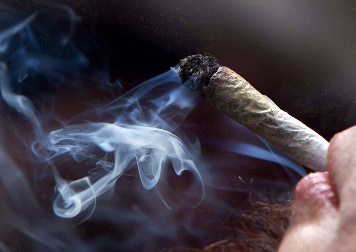 A man smokes a marijuana joint during a rally in downtown Vancouver, B.C., on Wednesday April 20, 2011. 