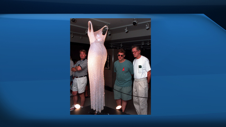 The dress worn by Marilyn Monroe when she sang "Happy Birthday" to President John F. Kennedy is examined by visitors to Christie's auction house in New York, Monday, July. 26, 1999. The dress is making what's believed to be its Canadian debut in rural Saskatchewan