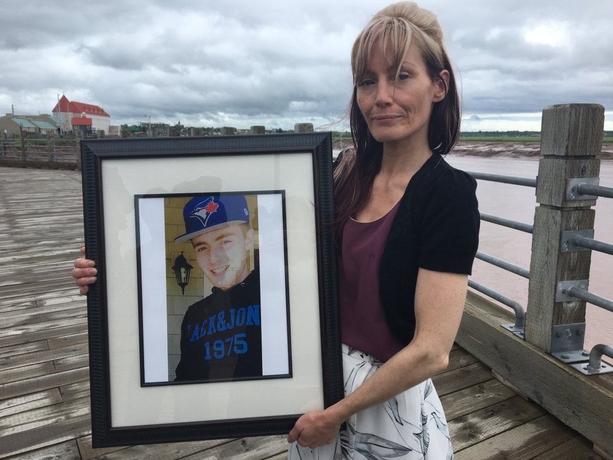 Kerri Matthews holds a portrait of her son Kingsley. He took his life last year on June 20 after suffering from mental illness and drug addiction. 