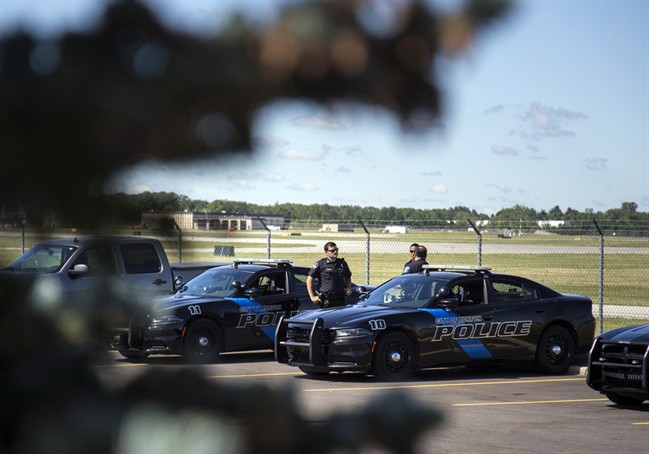 Burton Police Officers gather at Bishop International Airport, Wednesday morning, June 21, 2017, in Flint, Mich.