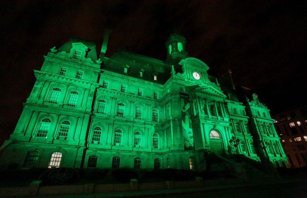 Montreal City Hall lights up green after the U.S, announced it will pull out of the Paris climate agreement, Thursday, June 1, 2017.