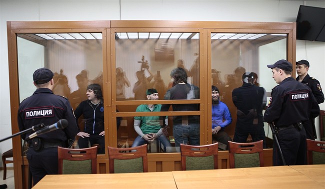 Defendants suspected of involvement in the killing of opposition leader Boris Nemtsov, stand in a glass enclosure during their trial in Russia, June 27.
