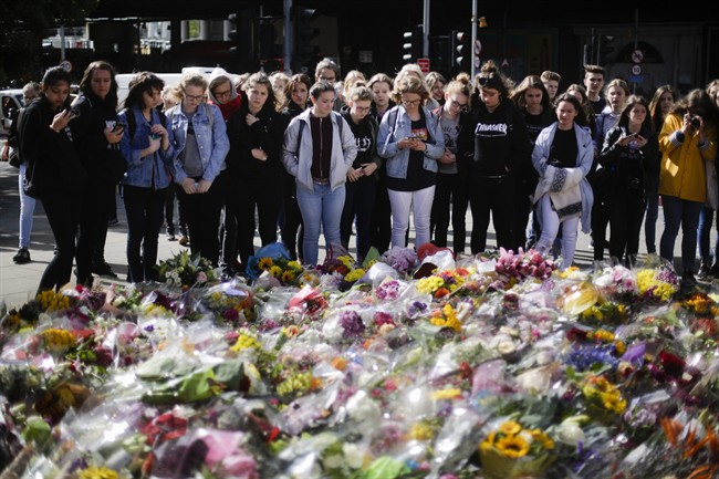 People look at floral tributes on London Bridge, Wednesday, June 7, 2017.