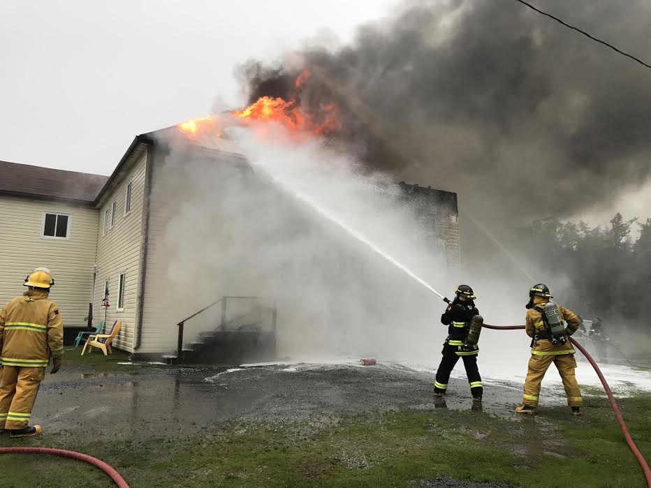 Firefighters from Musquash, New Brunswick's Fire - Rescue team battle a blaze on June 23, 2017.