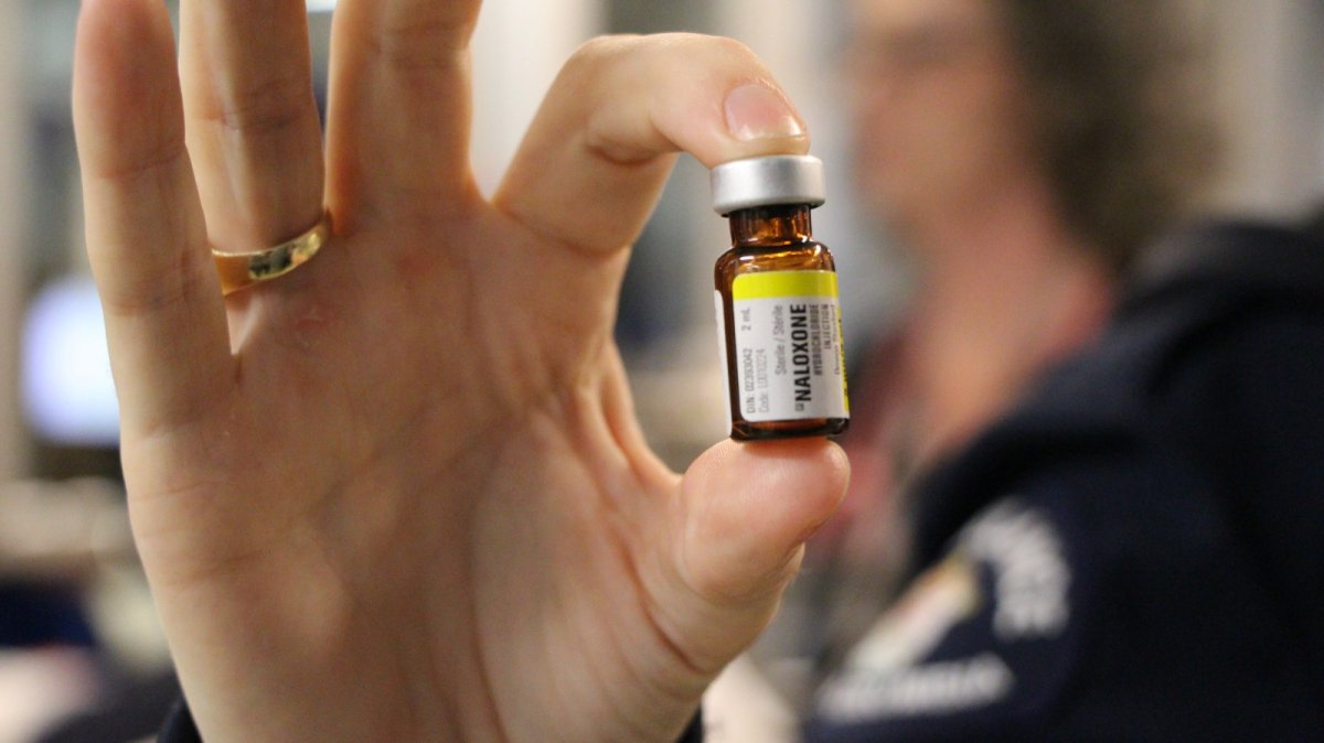 A paramedic displays a bottle of naloxone, the overdose-reversing drug administered daily to patients.