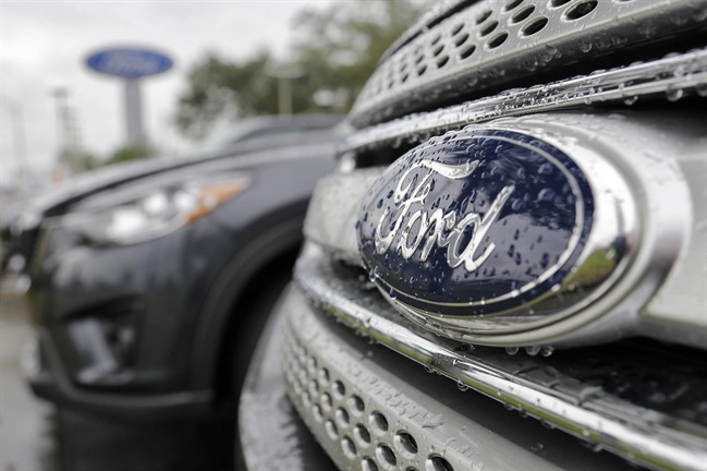 FILE - In this Jan. 12, 2015, file photo, Ford vehicles sit on the lot at a car dealership, in Brandon, Fla. 