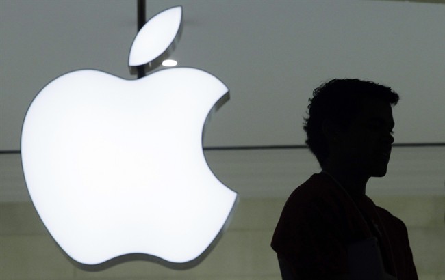 In this Wednesday, Dec. 7, 2011 file photo, a person stands near the Apple logo at the company's store in Grand Central Terminal, in New York.