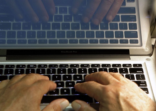 A file photo of a man typing on a keyboard.