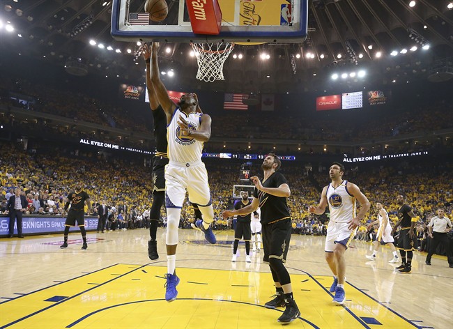 Golden State Warriors forward Kevin Durant shoots against the Cleveland Cavaliers during the first half of Game 2 of basketball's NBA Finals in Oakland, Calif., Sunday, June 4, 2017.