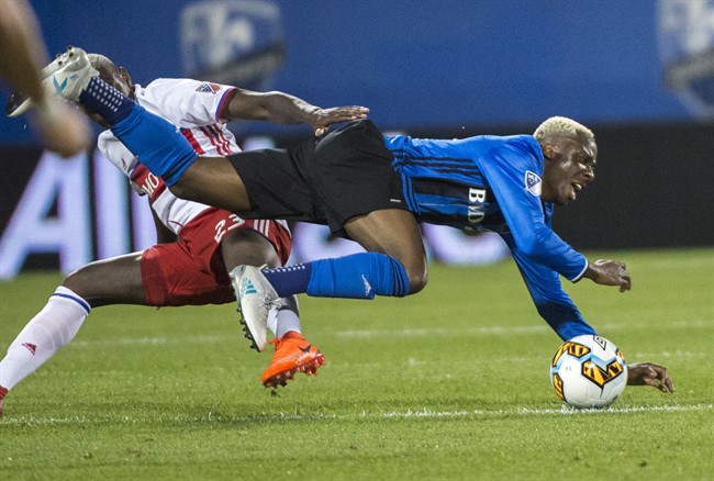 Montreal Impact midfielder Ballou Tabla, right, collides with Toronto FC defender Chris Mavinga during second half of the first leg of the Canadian Championship soccer final action, in Montreal on Wednesday, June 21, 2017.