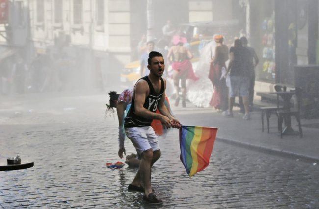 A participant of the Istanbul Pride Week march reacts after Turkish police use water cannons to disperse marchers, June 28, 2015. 