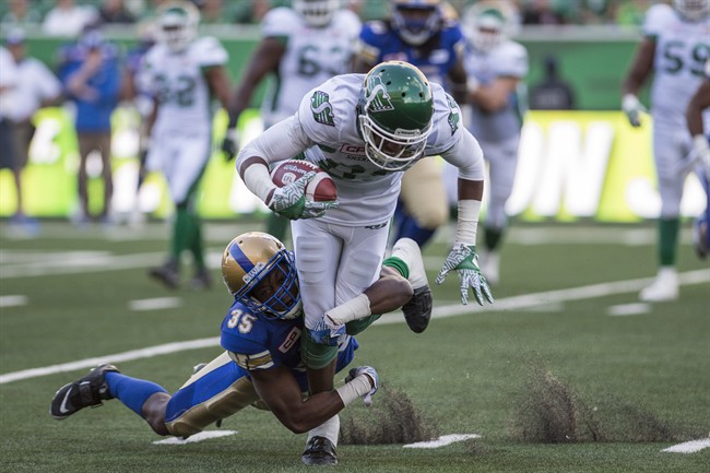 Terrence Frederick tackles Saskatchewan Roughriders wide receiver Mitchell Picton during a CFL pre-season game in Regina on Saturday, June 10, 2017.