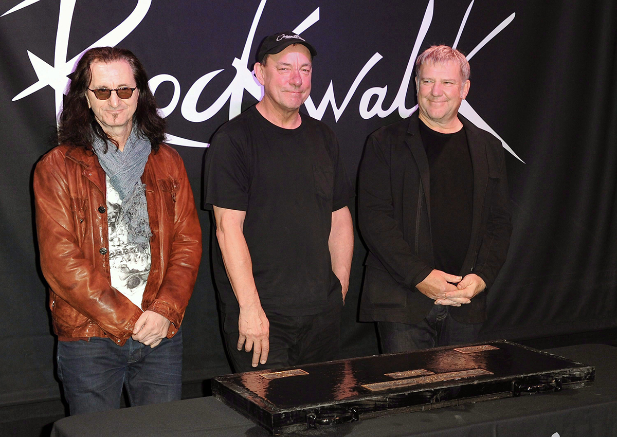 Members of the band Rush, from left, Geddy Lee, Neil Peart, and Alex Lifeson in 2012.