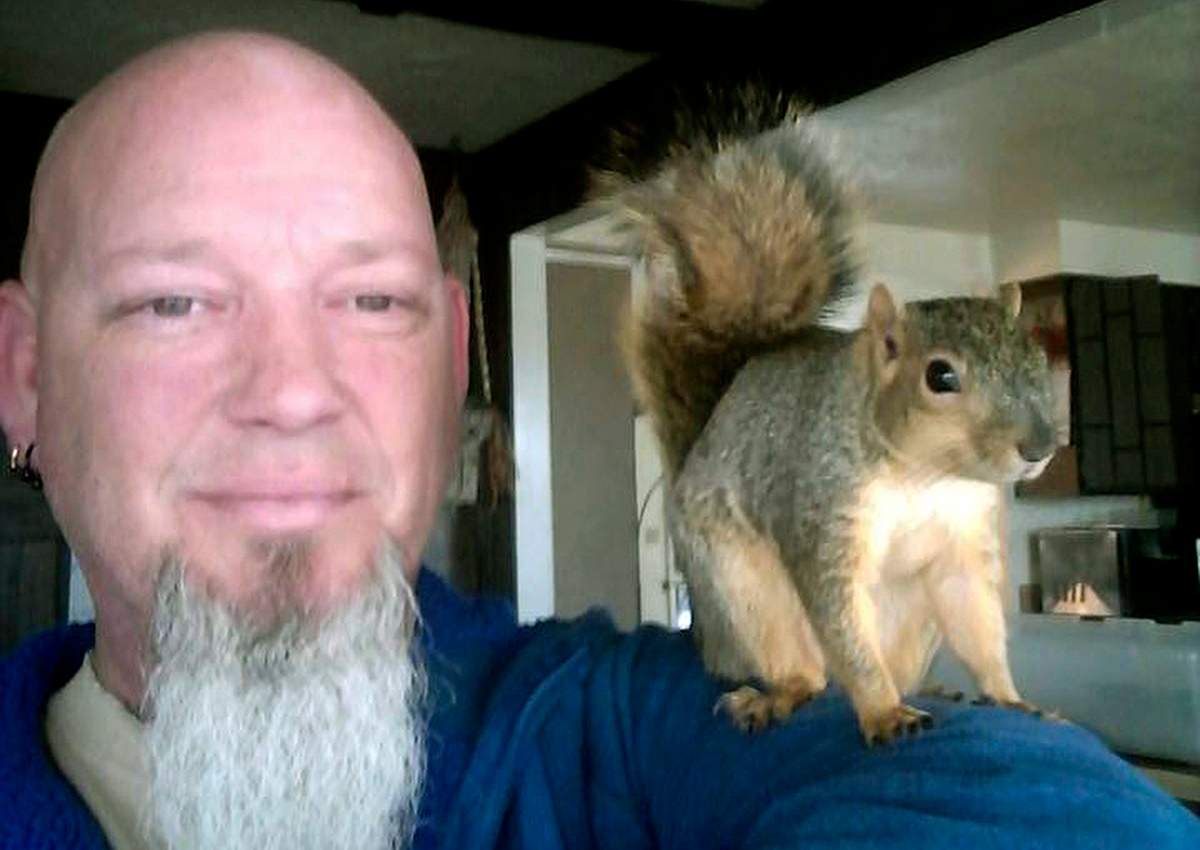 This undated photo provided by Adam Pearl shows Pearl with his pet squirrel Joey in Meridian, Idaho. 
