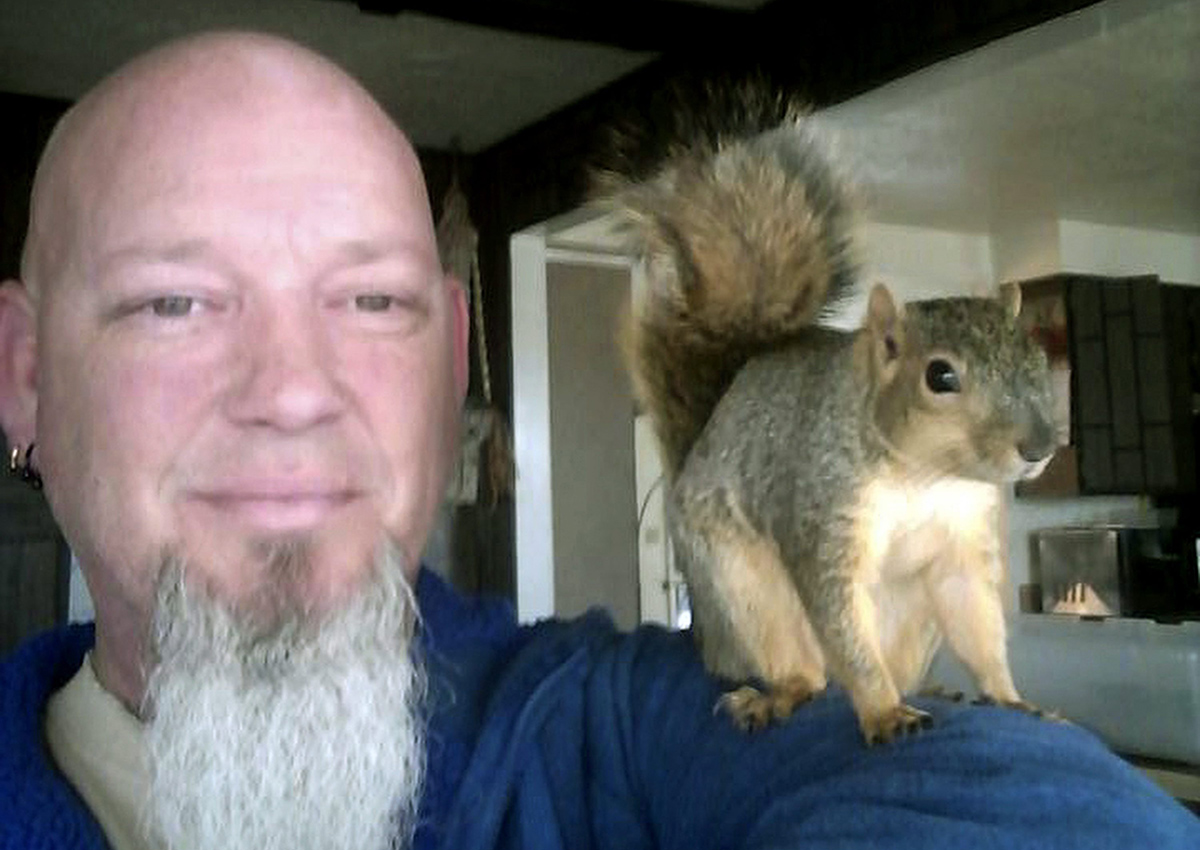 This undated photo provided by Adam Pearl shows Pearl with his pet squirrel Joey in Meridian, Idaho. 
