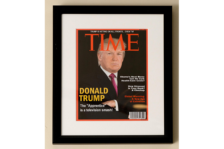 Framed portrait of President Donald Trump on the cover of a TIME Magazine hanging from a wall at the Trump National Doral Miami Golf Shop.