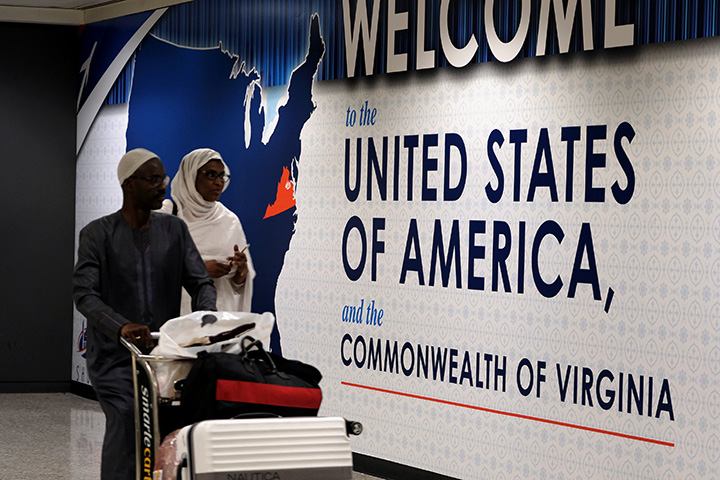 International passengers arrive at Washington Dulles International Airport after the U.S. Supreme Court granted parts of the Trump administration's emergency request to put its travel ban into effect pending further judicial review, in Dulles, Virginia, June 26, 2017. 