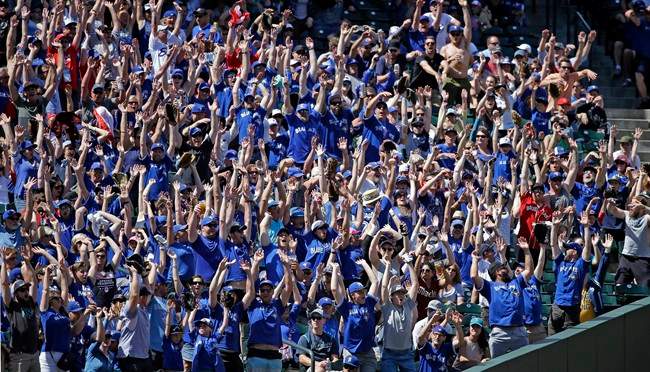 Fans, many wearing Toronto Blue Jays’ blue shirts, stand as a “wave” rolls through the stadium in the seventh inning of a baseball game against the Seattle Mariners, Sunday, June 11, 2017, in Seattle.