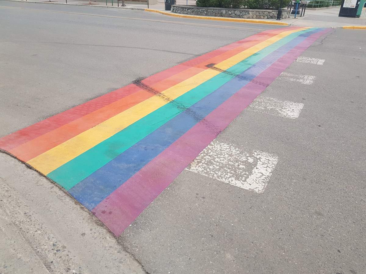 Treadmarks on Whitehorse's rainbow sidewalk left by vandals. 