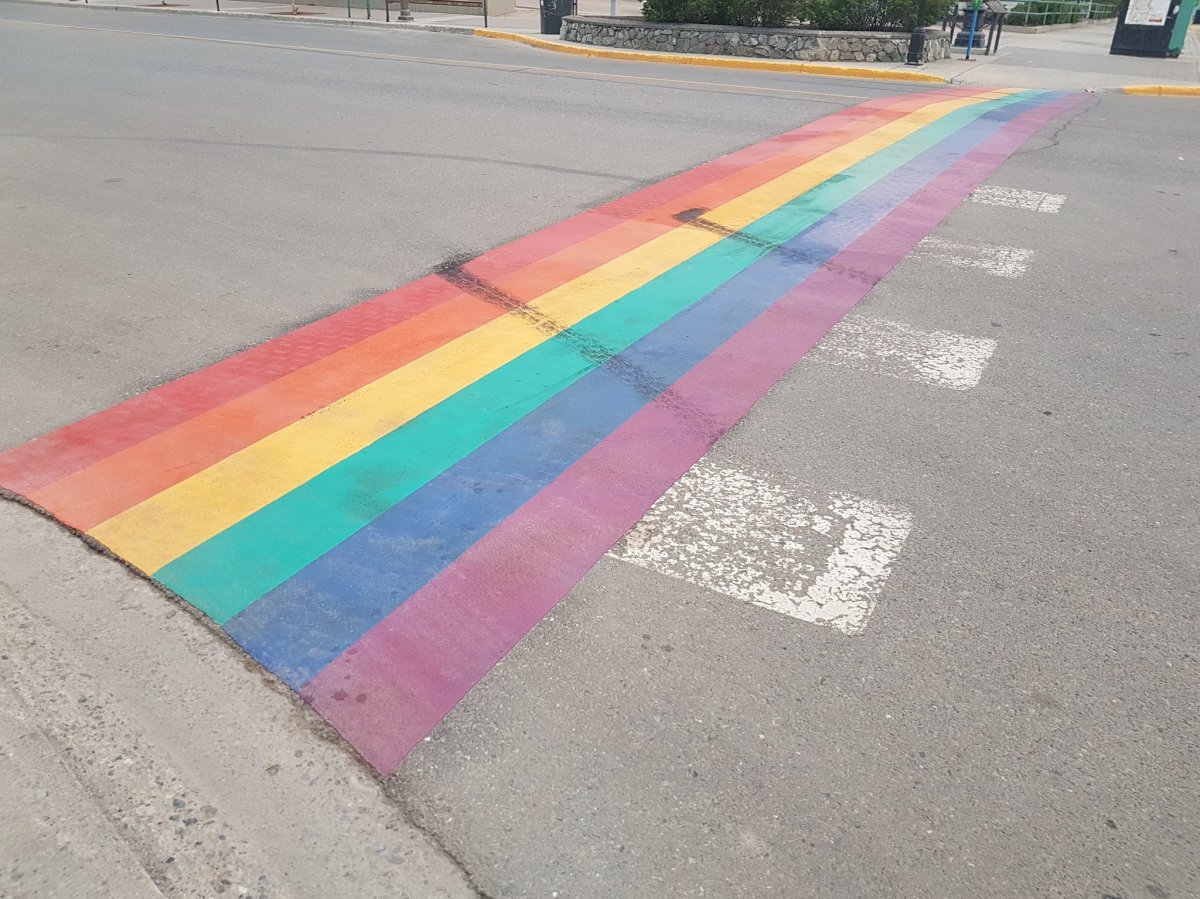 Treadmarks on Whitehorse's rainbow sidewalk left by vandals. 