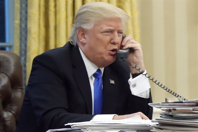In this Jan. 28, 2017 file photo, U.S. President Donald Trump speaks on the phone in the Oval Office of the White House in Washington. 