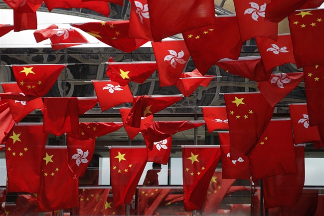 China and Kong Hong national flags are displayed outside a shopping center in Hong Kong Wednesday, June 28, 2017 to mark the 20th anniversary of Hong Kong handover to China.
