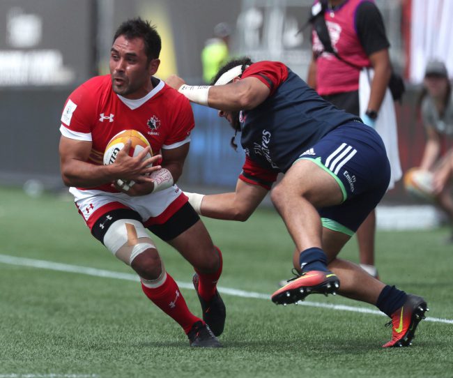 Canada's Phil Mack (left) avoids a tackle from Mike Te'o of USA during a 2019 Rugby World Cup Qualifier at Tim Horton's Field in Hamilton, Ont., June 24, 2017. 