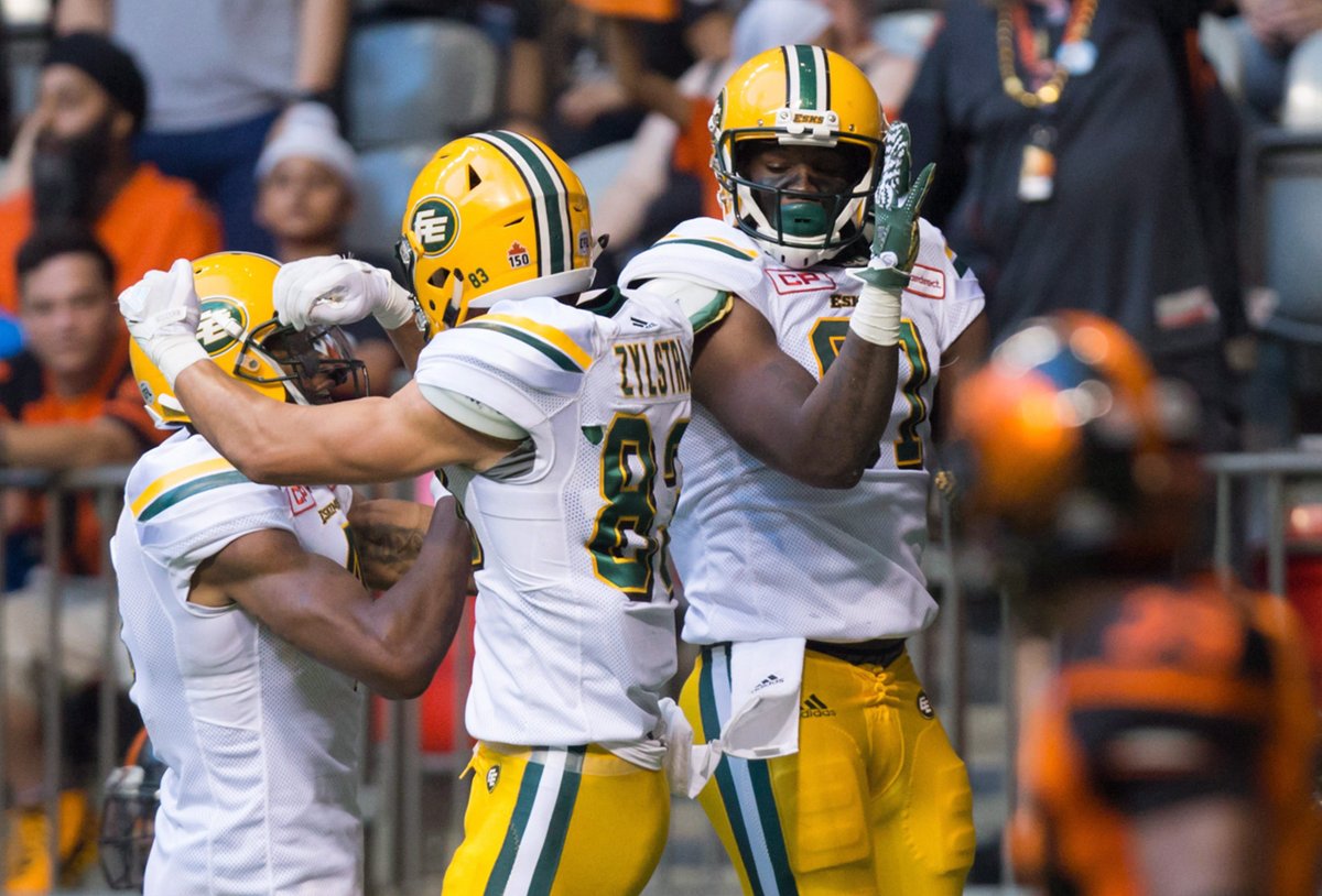 Edmonton Eskimos' Adarius Bowman, from left to right, Brandon Zylstra and D'haquille Williams celebrate Williams' touchdown against the B.C. Lions during the first half of a CFL football game in Vancouver, B.C., on Saturday, June 24, 2017. 