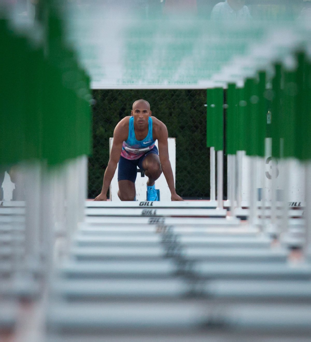 Canada's Damian Warner, of London, Ont., is framed by hurdles as he waits in the starting blocks before racing to a first place finish in the men's 110 metre hurdles at the Harry Jerome International Track Classic in Coquitlam, B.C., on Wednesday June 28, 2017. THE CANADIAN PRESS/Darryl Dyck.
