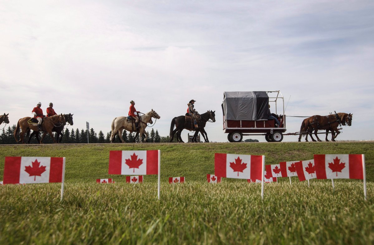 RCMP take part in the re-enactment of the March West, near Fort Saskatchewan Alta, on Friday June 30, 2017. They are following the historic trail ride that first brought the then North West Mounted Police to western Canada.