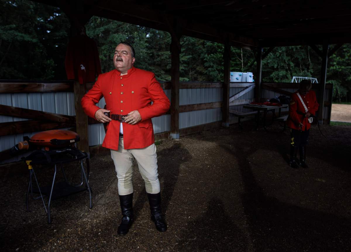 RCMP Sergeant Jack Poitras gets ready to take part in the re-enactment of the March West, near Fort Saskatchewan, Alta., on June 30, 2017.