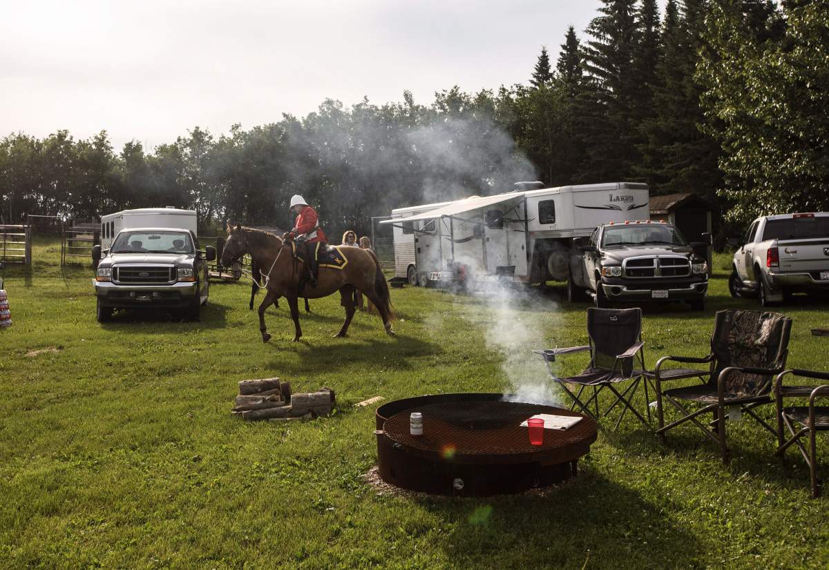 RCMP prepare to leave camp and take part in the re-enactment of the March West, near Fort Saskatchewan, Alta., on June 30, 2017.