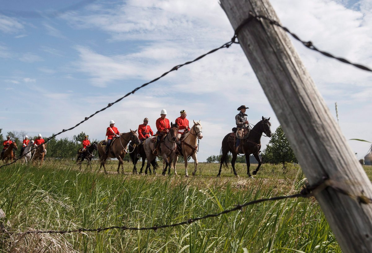 RCMP take part in the re-enactment of the March West, near Fort Saskatchewan, Alta., on Friday, June 30, 2017. They were following the historic trail ride that first brought the North-West Mounted Police to western Canada.