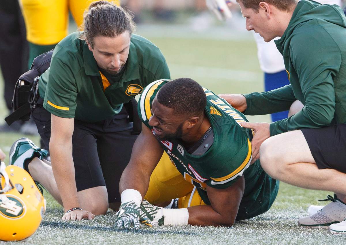 Edmonton Eskimos’ John White (30) is injured during first half CFL action against the Montreal Alouettes, in Edmonton on Friday, June 30, 2017.