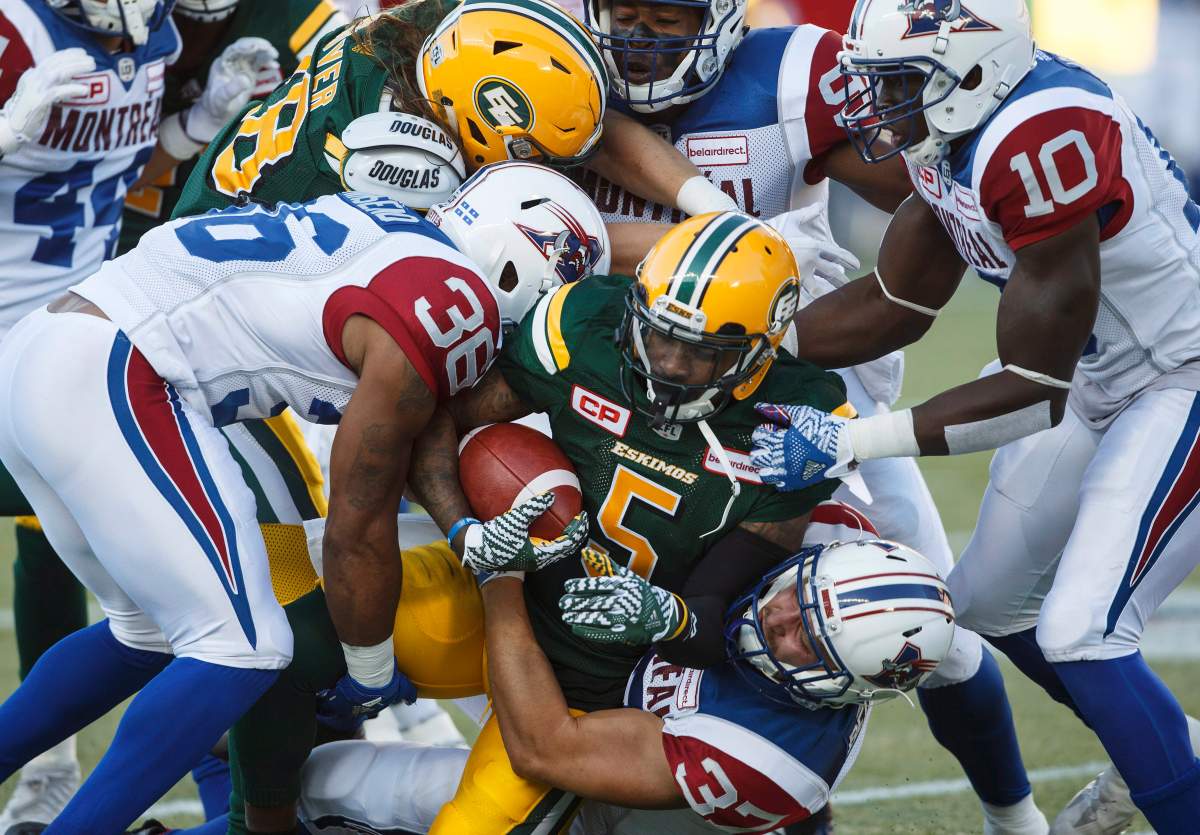 Montreal Alouettes' Martin Bedard (37) takes down Edmonton Eskimos' Travon Van (5) during first half CFL action in Edmonton on Friday, June 30, 2017. 