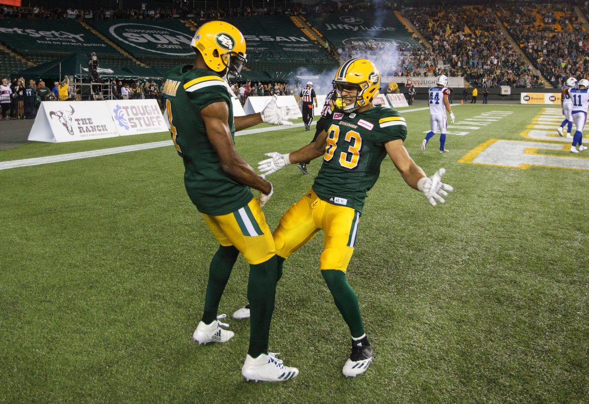 Edmonton Eskimos' Adarius Bowman (4) and Brandon Zylstra (83) celebrate a touchdown during second half CFL action against the Montreal Alouettes, in Edmonton on Friday, June 30, 2017. 