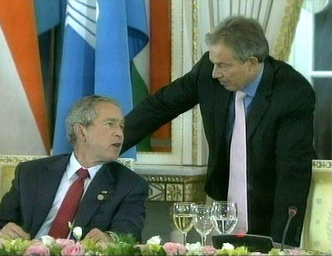 U.S. President George W. Bush talks with British Prime Minister Tony Blair, right, during a private luncheon towards the end of the G8 summit in St Petersburg, Russia, July 17, 2006, in this image made from television.