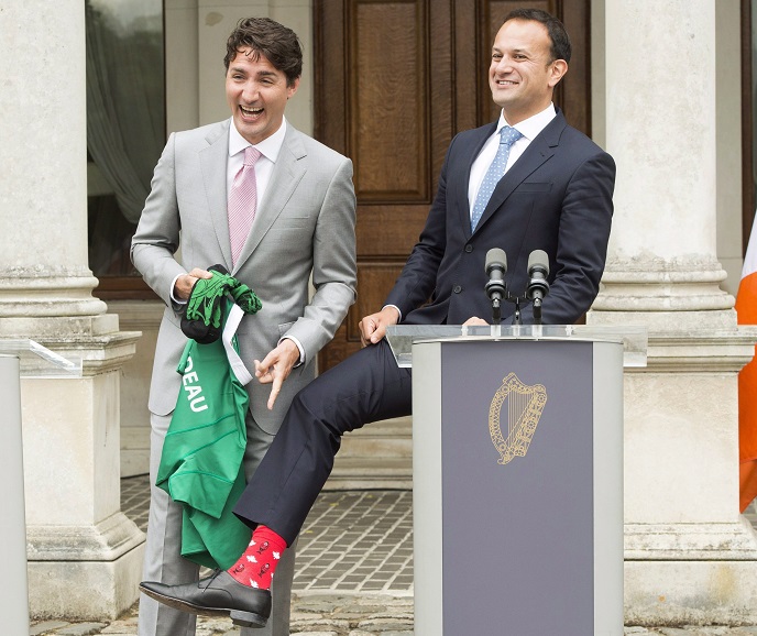 Prime Minister Justin Trudeau laughs as Irish Taoiseach Leo Varadkar shows him his Maple Leaf socks during their press conference at Farmleigh House Tuesday in Dublin.