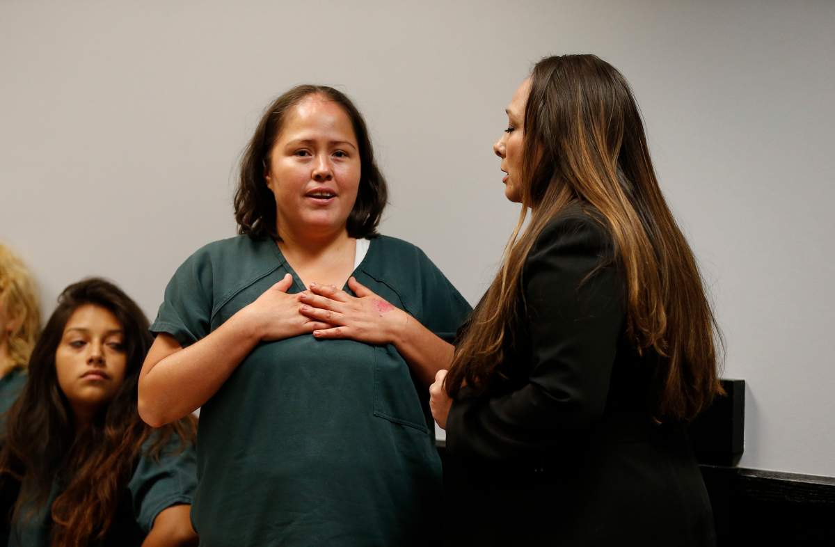 Isabel Martinez, second from right, speaks to a magistrate judge through a Spanish language interpreter during her first court appearance Friday, July 7, 2017, in Lawrenceville, Ga.