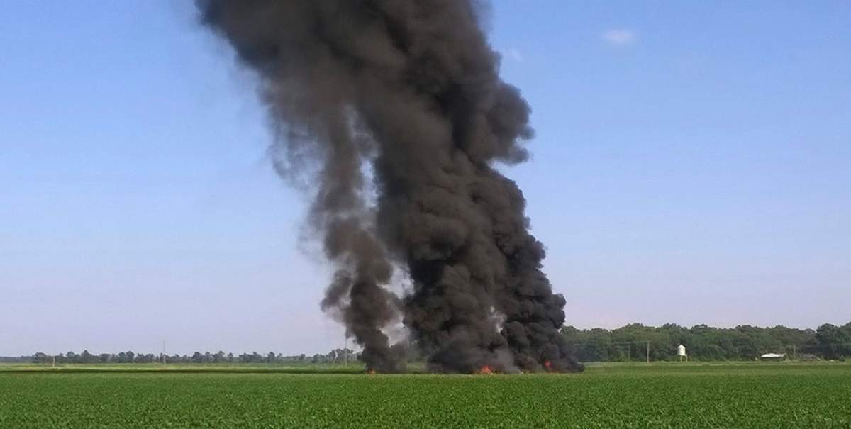 In this photo provided by Jimmy Taylor, smoke and flames come from the wreckage after a military transport airplane crashed in a field near Itta Bena, Miss., on the western edge of Leflore County, Monday, July 10, 2017, killing several. (Jimmy Taylor via AP)
