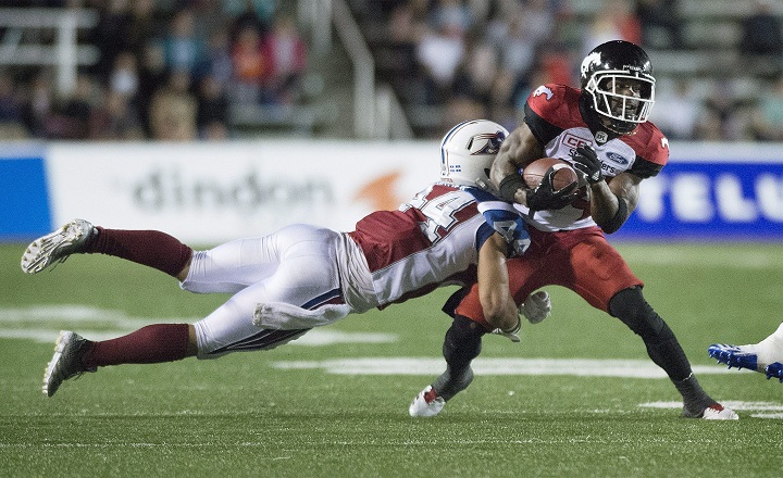 Montreal Alouettes' Branden Dozier (44) tackles Calgary Stampeders' Roy Finch during second half CFL football action in Montreal, Friday, July 14, 2017.