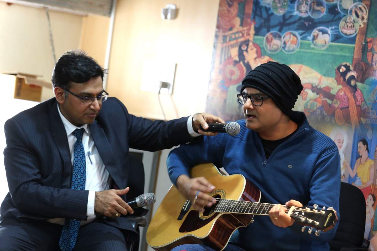 Doctor Sharan Srinivasan, Senior Consultant Neurosurgeon with Abhishek Prasad discuss a seven-hour brain surgery on July 11, 2017 that required Prasad to remain awake and play the guitar. EPA/JAGADEESH NV