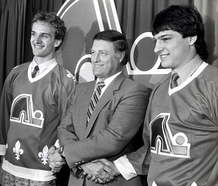 Maurice Filion, director manager of the Quebec Nordiques, welcomes Mario Brunetta, left, and Jason Lafreniere to the team, in Quebec City on June 4, 1986. Filion died Saturday morning at the age of 85.