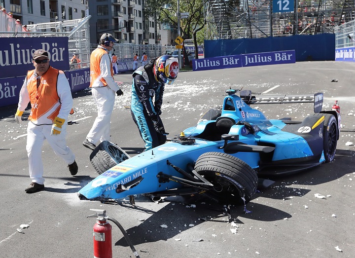 Sebastien Buemi, of Switzerland, checks the damage to his car after crashing during the second practice session at the Montreal Formula ePrix electric car race, in Montreal on Saturday, July 29, 2017.