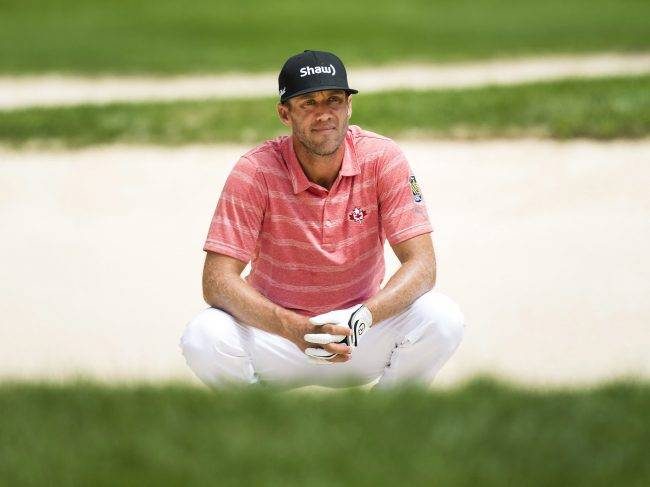 Graham DeLaet looks out from the bunker on the 13th hole during the Canadian Open golf tournament at Glen Abbey golf club, in Oakville, Ont., on Saturday, July 29, 2017.