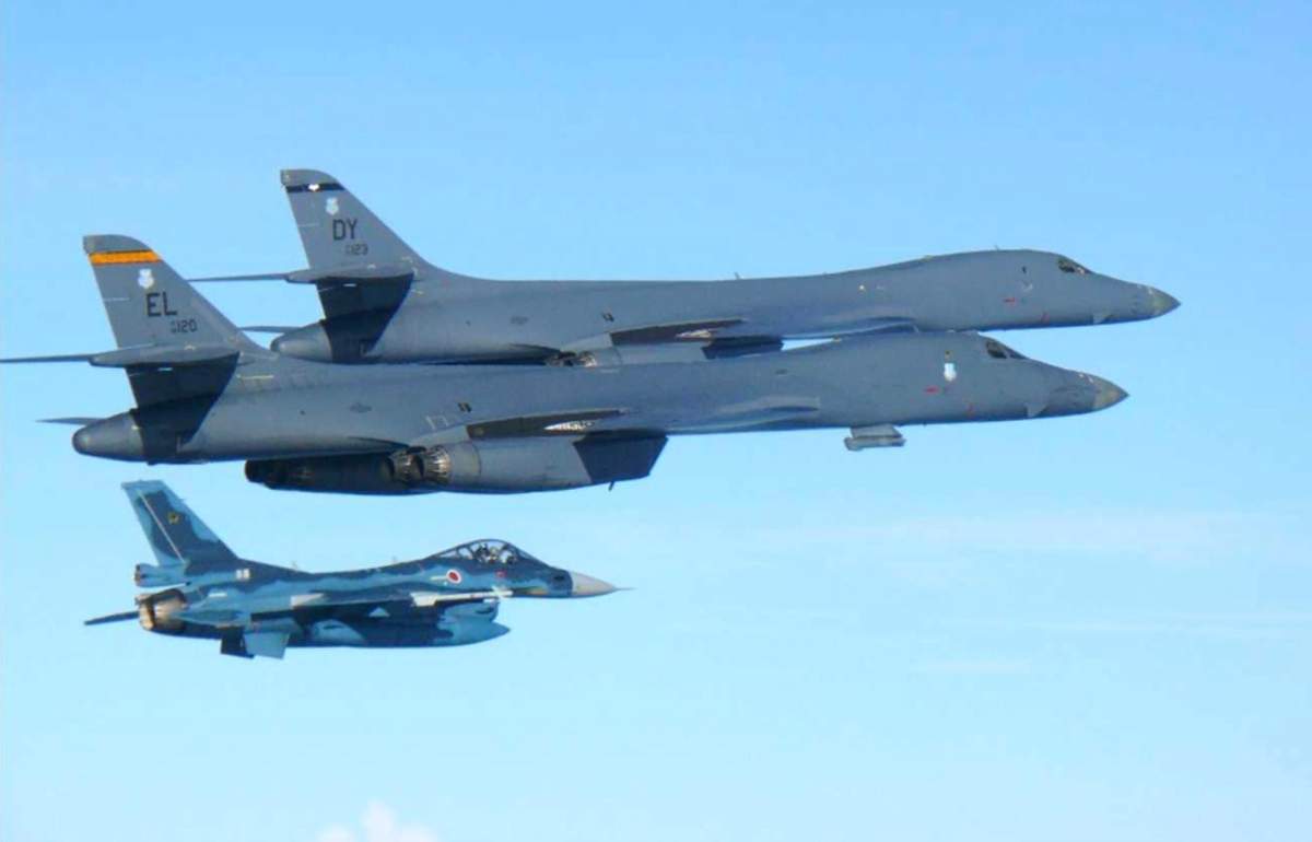In this photo released by Japan Air Self Defense Force, U.S. Air Force B-1B bombers, top, fly with a Japan Air Self Defense Force F-2 fighter jet over Japan's southern island of Kyushu, just south of the Korean Peninsula, during a Japan-U.S. joint exercise Sunday, July 30, 2017.  