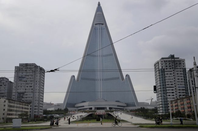Walls set up to keep people out of a construction area around the gargantuan Ryugyong Hotel were pulled down as the North marked the anniversary of the Korean War armistice to reveal two broad new walkways leading to the building and the big red propaganda sign declaring that North Korea is a leading rocket power.